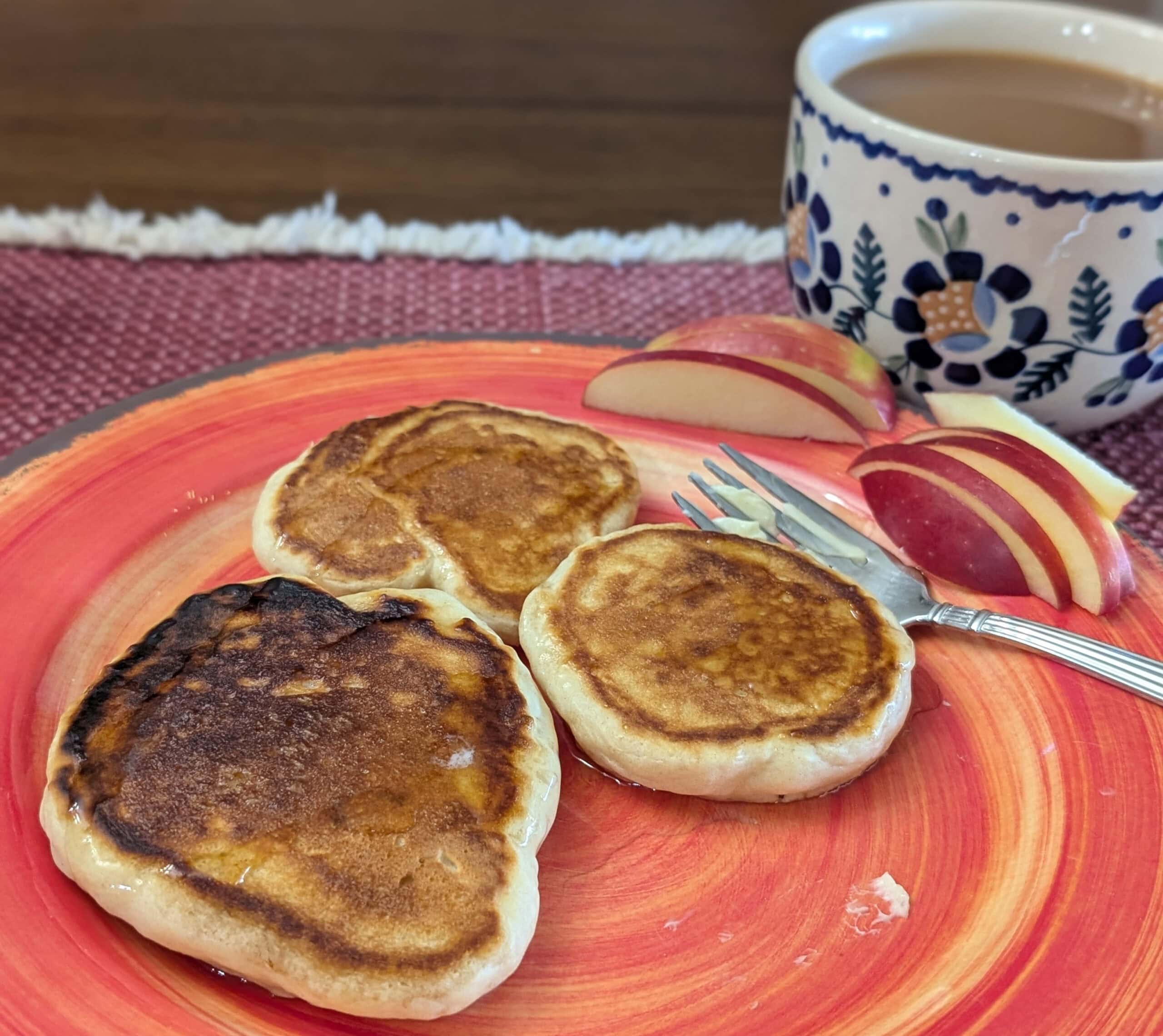 Stack of fluffy homemade sourdough pancakes on a plate ready to be served